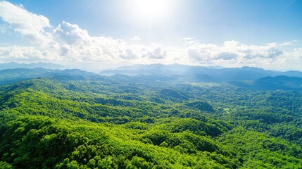 Lush green mountain range aerial view, sunny day, cloud sky, nature travel background