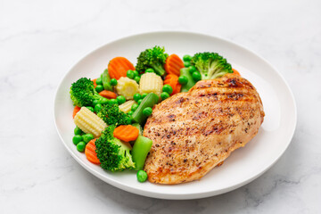 grilled  chicken breast with cooked  vegetables on white plate, healthy weight loss meal,