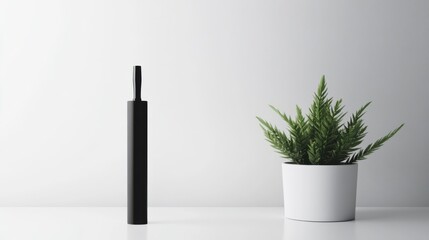 Vaping device on a clean white desk with a small plant. Featuring simplicity and tranquility