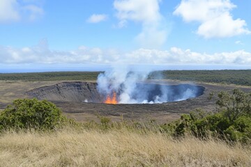 Fototapeta premium Bubbling lava fills volcanic crater under cloudy blue skies at Hawaii's Kilauea. Generative AI