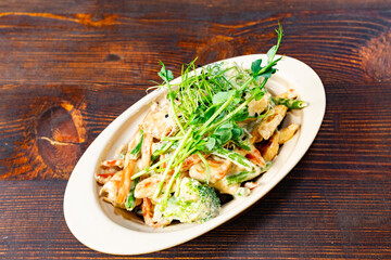 Delicious creamy pasta dish with fresh vegetables and herbs