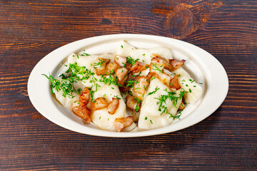 Delicious dumplings served with crispy bacon and fresh herbs