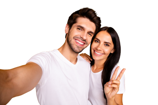Photo of two people taking selfies showing v-sign saying hi to all followers wear casual clothes isolated yellow color background