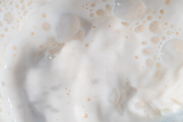 Milk water liquid white color drink and food texture background, Beautiful natural caw milk wave and bubble splash texture with macro on top view, Healthy food daily
