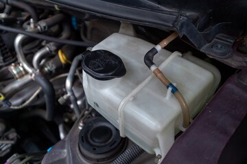 A tube of car window washer fluid. The wiper fluid tube for the windshield.