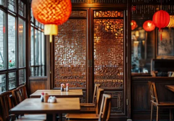   elegant restaurant interior design, wood-grain walls with windows on the left side of the picture. In front of the walls, there are tables and chairs for dining. Behind them, ancient wooden door stan © Eva