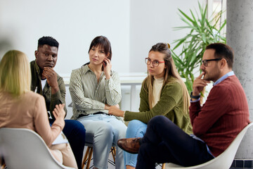 Support Group Engages in Discussion in Bright Modern Meeting Room