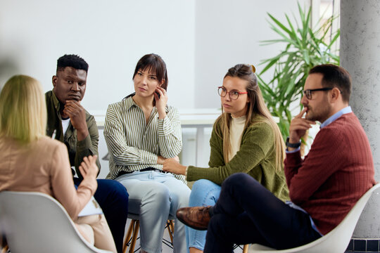 Support Group Engages in Discussion in Bright Modern Meeting Room