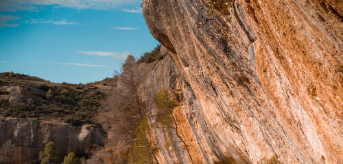 Beautiful road among the rocky yellow-red mountains on the southern mediterranean coast in the rays of the sun at sunset.