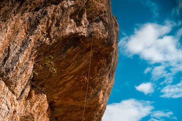 Beautiful road among the rocky yellow-red mountains on the southern mediterranean coast in the rays of the sun at sunset.