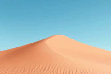 Sand dune rising under clear blue sky in desert landscape