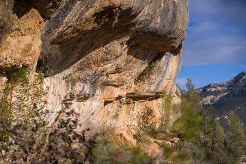 Beautiful road among the rocky yellow-red mountains on the southern mediterranean coast in the rays of the sun at sunset.