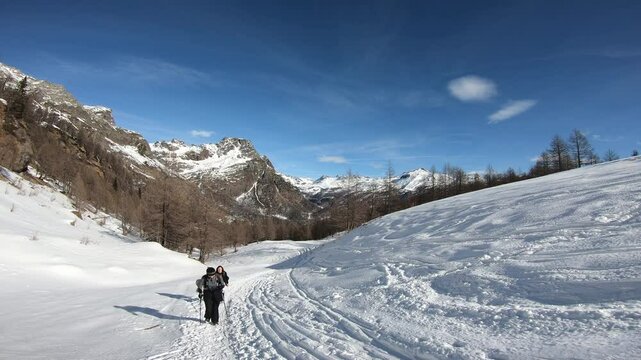 Solo Snow Hiker Crossing a Vast Alpine Snowfield at Alpe Devero, Monte Cazzola, Italian Alps