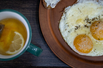 Breakfast with Sunny-Side-Up Eggs and Lemon Tea
