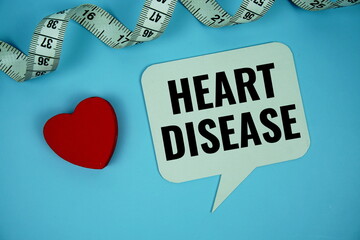 Heart Disease text on speech bubble with red heart with measure tape top view on blue background