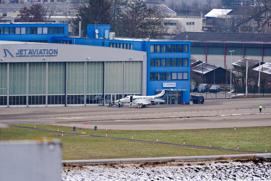 Privat jet Embraer Phenom 100 D-ISTP parked in front of Jet Aviation hangar at Swiss Airport Z&uuml;rich Kloten on a gray winter day. Photo taken February 17th, 2025, Zurich Kloten, Switzerland.