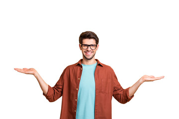 Portrait of his he nice attractive cheerful cheery glad successful content brunet guy holding copy space invisible objects on palms isolated over beige color pastel background