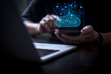 Cloud technology concept showcasing glowing blue cloud icon over smartphone near laptop for seamless data transfer and IT data cybersecurity protection technology ai website code software