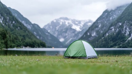 Solo camping tent by mountain lake