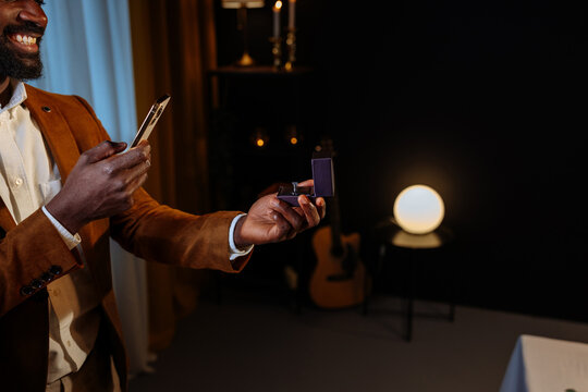 Elegant man showing engagement ring during video call