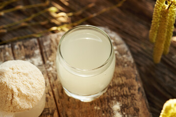 Fresh natural whey in a glass cup with whey protein powder