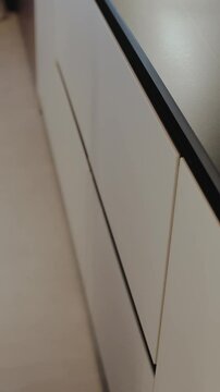 The white kitchen drawer that closes has an elegant design and plenty of open space for organization. No people shot. Vertical video