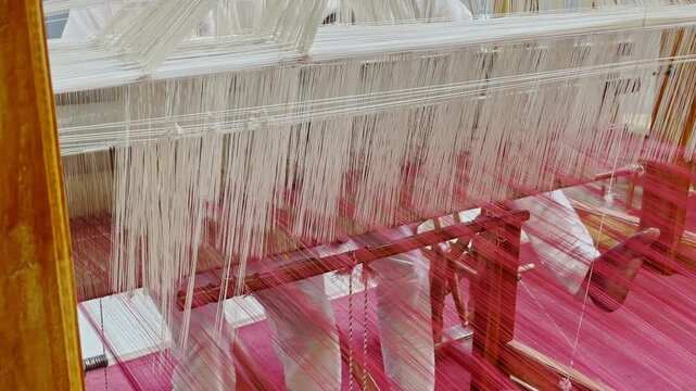 Handloom cloth is crafted by interlacing warp and threads on a manual loom. Skilled artisans dye, spin, and weave fibers like cotton or silk, creating fabrics India