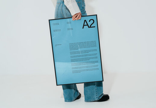 Mockup Of Woman Holding Vertical Customized A2 Frame, Side View