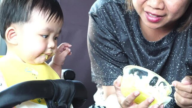 The baby is enjoying his nutritious meal.