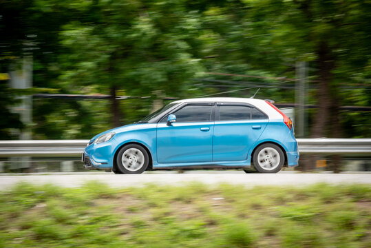 Nakhonsawan, Thailand - July 2024: MG MG3, A blue car to speed running on the highway, on July 27, 2024, at Nakhon Sawan, Thailand.