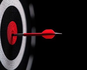 A red dart strikes the bullseye of a dartboard on a dark background.