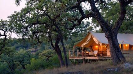 Luxurious safari tent overlooking hills at dusk