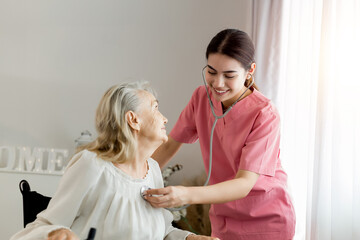 Caucasian caregiver lady consulting with elderly woman patient. Wheelchair disability rehabilitation and nurse at nursing home. Healthcare support and caregiver with senior woman for medical help.