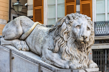 A close-up of a statue of a lion near a church in Genoa, Italy