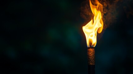 Bright Flame Dancing from a Torch in a Dark Background at Night