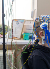 A boy's brain is examined on an EEG machine. Electroencephalogram is performed in a hospital...