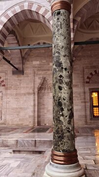 Courtyard of Historic Bayezid II Mosque with Marble Columns and ablutions fountain in the middle, Istanbul, Turkey