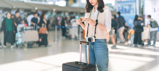 Standing tourist woman passenger at international airport terminal for holidays solo travel