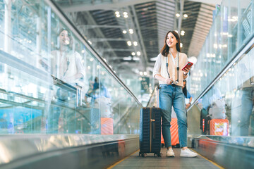 Standing tourist woman passenger at international airport terminal for holidays solo travel