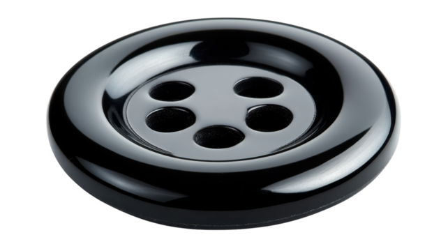 Black button with four holes highlighting its sleek design and texture for sewing projects and crafts