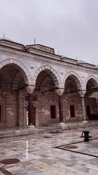 Courtyard of Historic Bayezid II Mosque with Marble Columns and ablutions fountain in the middle, Istanbul, Turkey