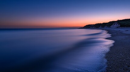 Obraz premium Tranquil Dunes: Dawn on a Pebble Beach Coast