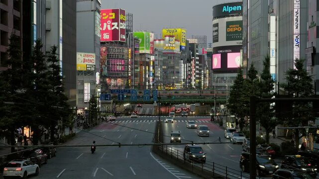 Twilight in Tokyo : Bustling Metropolis. Cars Heading Home Line the Roads. Commuter Trains Crossing Railway Bridges. Neon Signs Beginning to Shine Brightly at Dusk | Kabuki-cho, Shinjuku, Tokyo, Japan