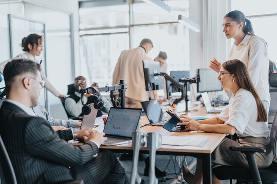 A diverse group of business people working collaboratively in a modern open-plan office. The image showcases teamwork, technology, and an inclusive work environment.