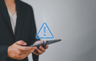 System warning hacked alert, cyber attack on computer network.Businessman using tablet with warning sign notification error, Malicious software,virus and cybercrime, Cybersecurity,data breach.