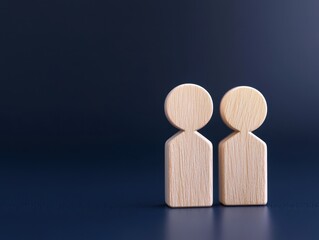 Wooden figures representing human connection and relationships on a blue background.
