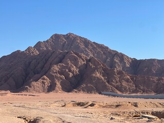 Rocks in the desert with sand of Egypt blue sky and sun