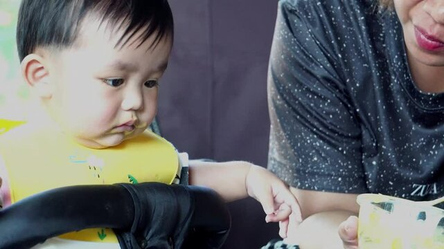 The baby is enjoying his nutritious meal.