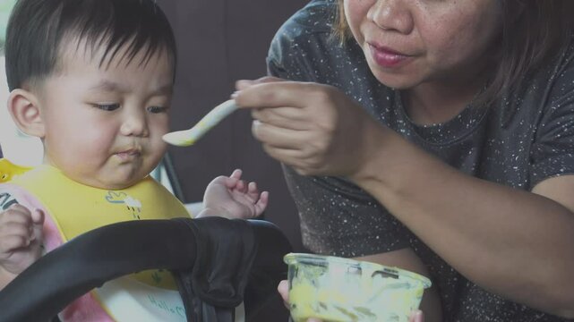 The baby is enjoying his nutritious meal.