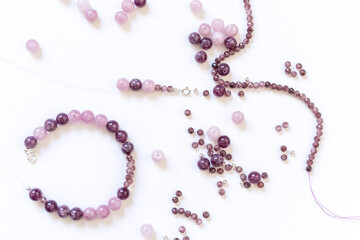 Preparing gemstone jewelry. Natural stones pink quartz, Amethyst, silver. Craft, handmade conception. Free space for text.